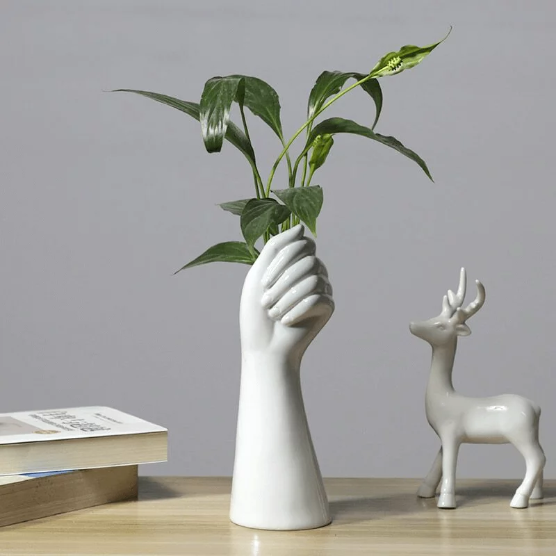 vase main avec une plante verte