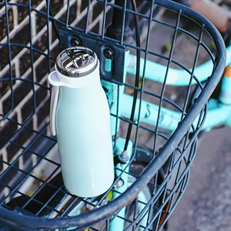 gourde isotherme vintage dans un panier de vélo